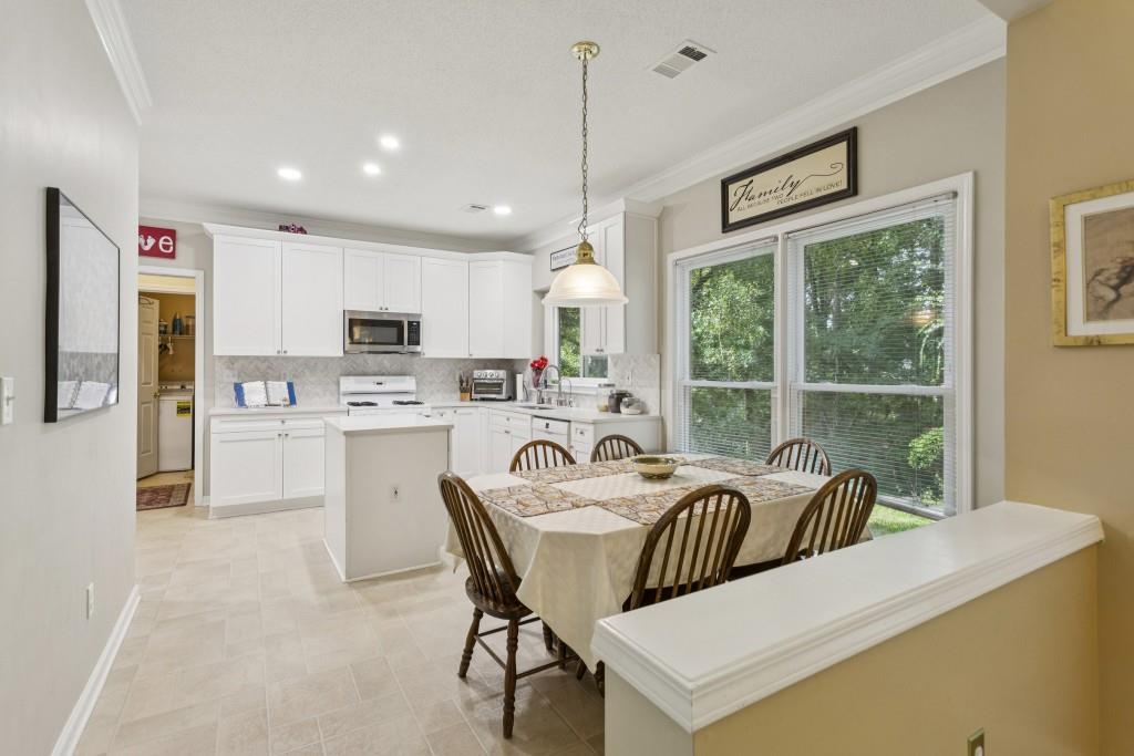 4815 Tanners Spring Drive Alpharetta, GA 30022 - Photo 13 of 45 a living room with stainless steel appliances granite countertop furniture and a large window