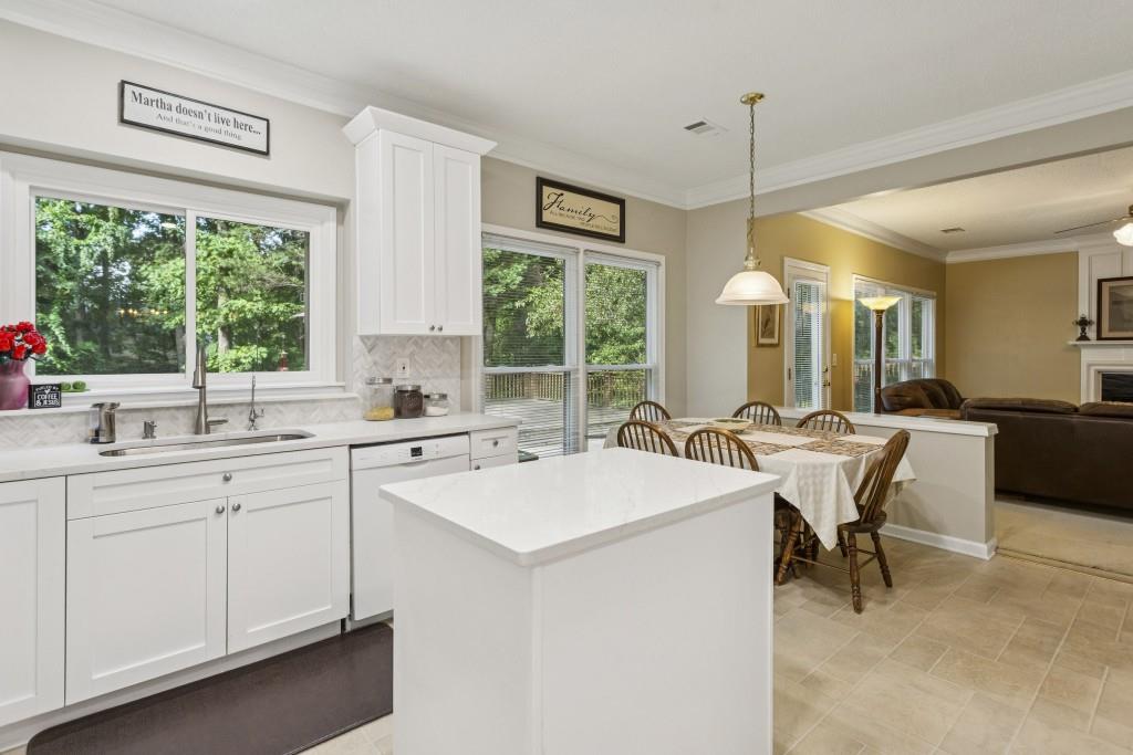 4815 Tanners Spring Drive Alpharetta, GA 30022 - Photo 16 of 45 a kitchen with a sink windows and chairs