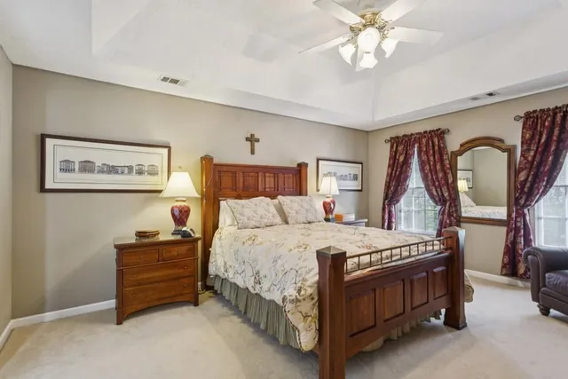 a bedroom with a bed and a chandelier