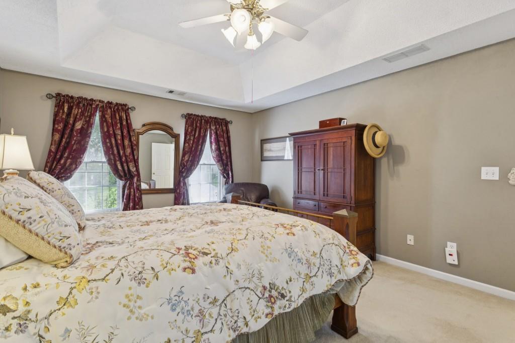 4815 Tanners Spring Drive Alpharetta, GA 30022 - Photo 21 of 45 a bedroom with a bed and dresser with mirror