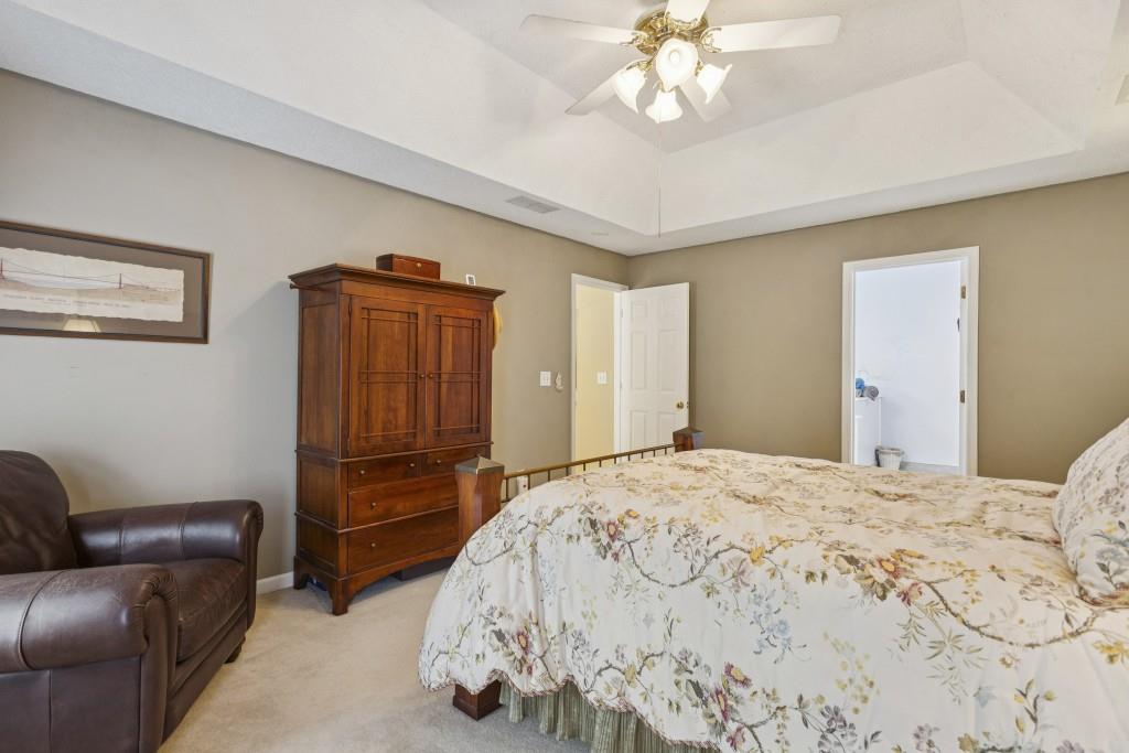 4815 Tanners Spring Drive Alpharetta, GA 30022 - Photo 22 of 45 a bedroom with a bed dresser and wooden floor