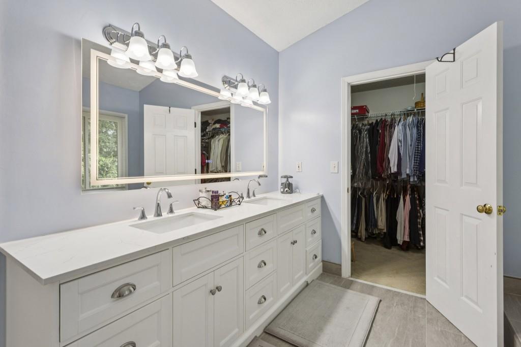 4815 Tanners Spring Drive Alpharetta, GA 30022 - Photo 24 of 45 a bathroom with a double vanity sink and a mirror