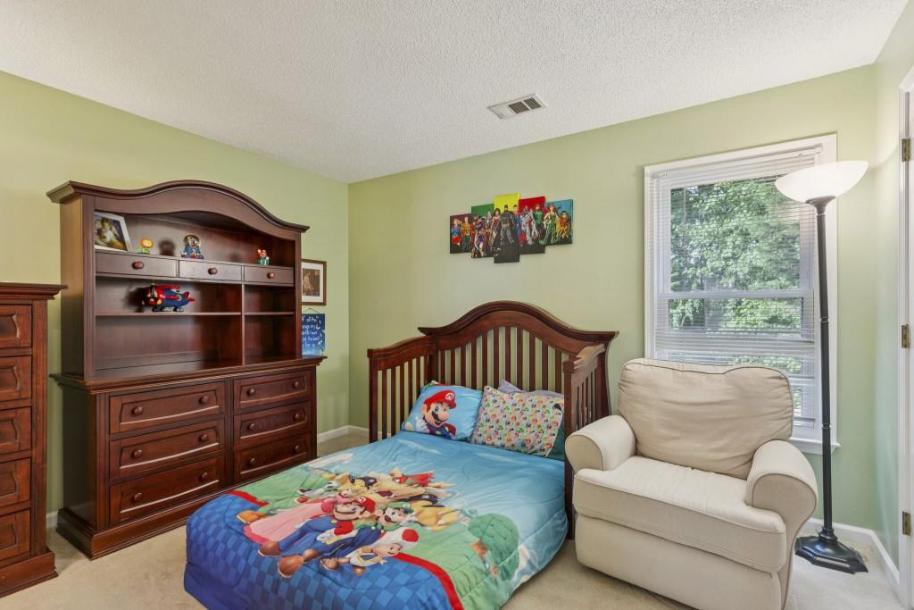 4815 Tanners Spring Drive Alpharetta, GA 30022 - Photo 29 of 45 a bedroom with a bed and a dresser
