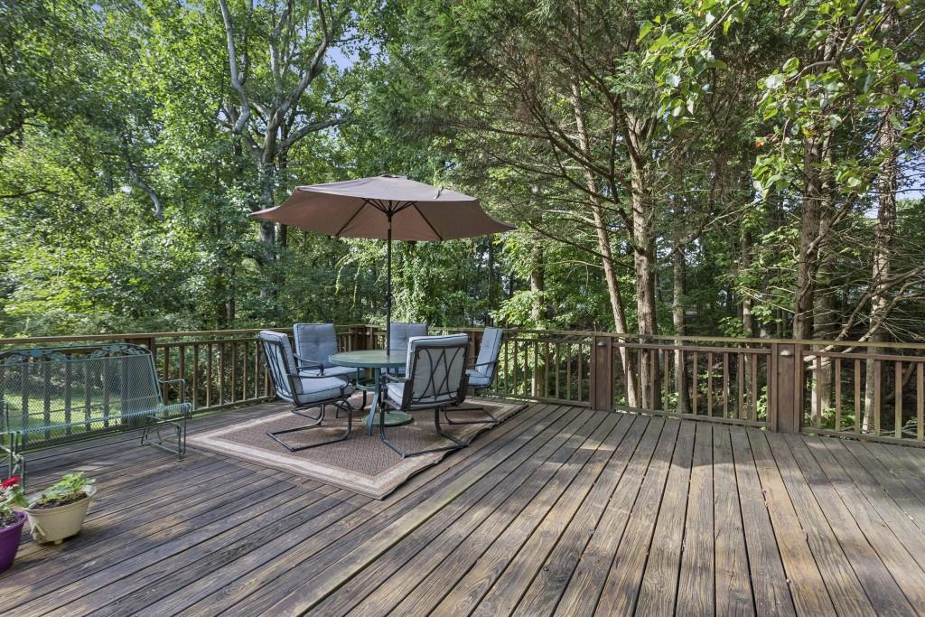 4815 Tanners Spring Drive Alpharetta, GA 30022 - Photo 35 of 45 a view of balcony with outdoor seating and wooden floor