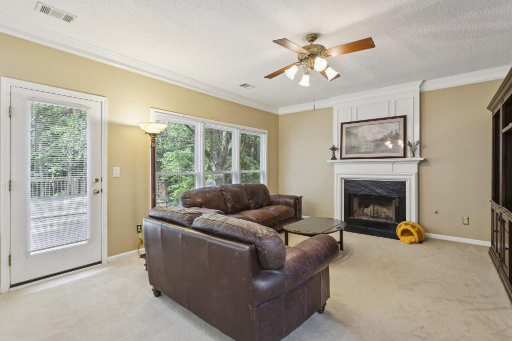 4815 Tanners Spring Drive Alpharetta, GA 30022 - Photo 9 of 45 a living room with furniture and a fireplace