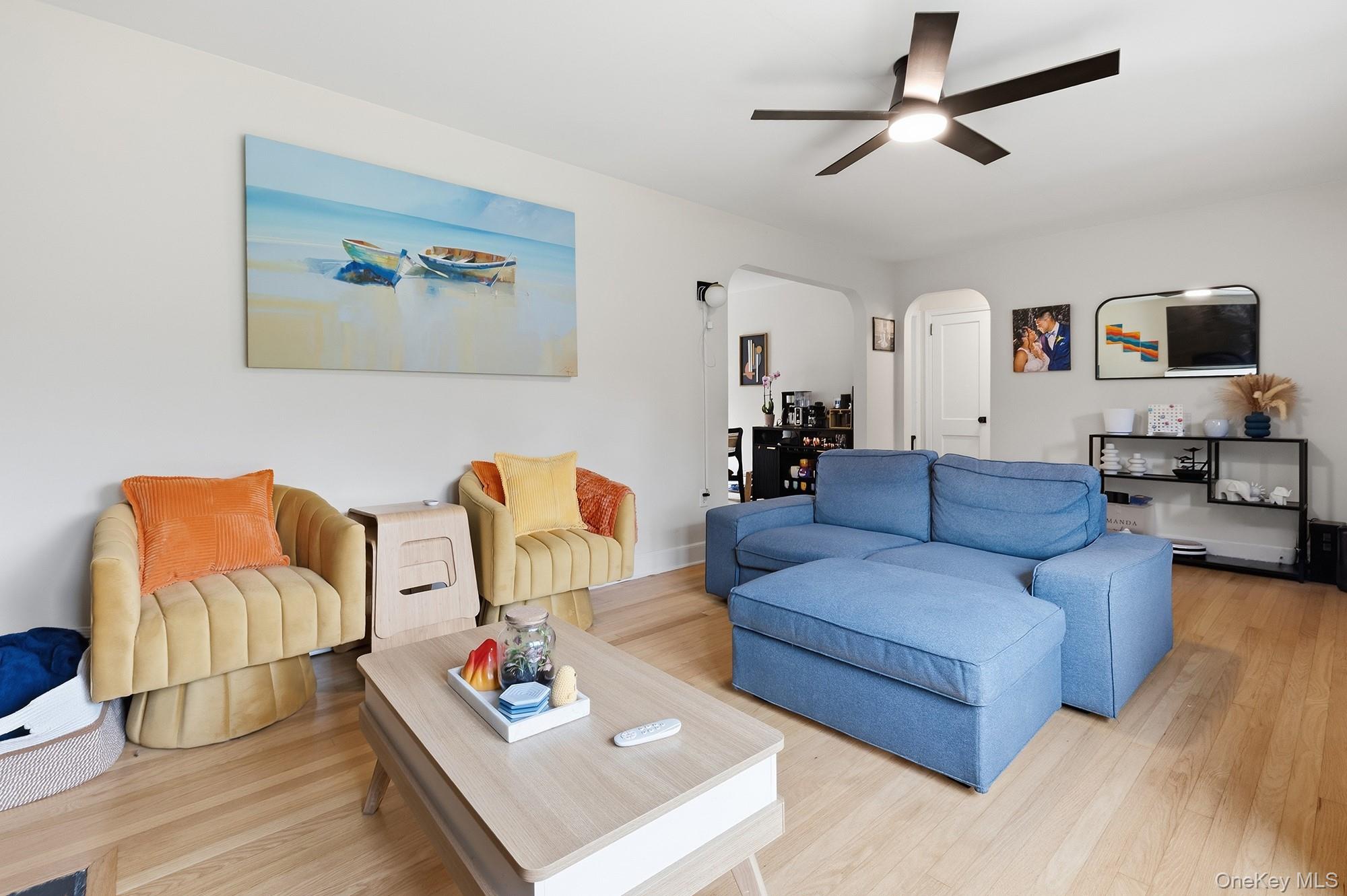 114 Cramer Road Poughkeepsie, NY 12603 - Photo 6 of 31 Living area featuring wood-finish flooring, a modern ceiling fan with integrated lighting, and light-colored walls