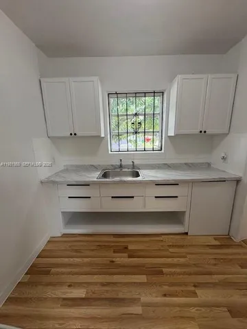 a bathroom with a sink and a window