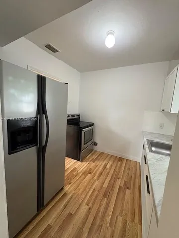 a view of a livingroom with wooden floor