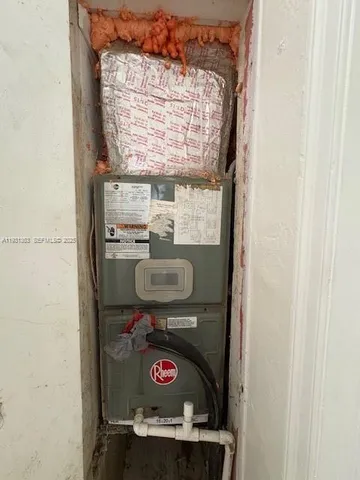 a bathroom with a washing machine and a shower