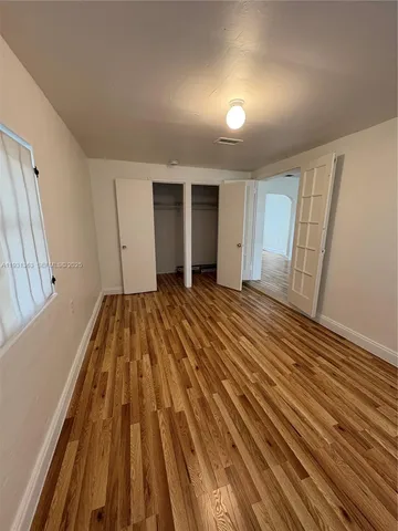 a view of a room with wooden floor and stairs