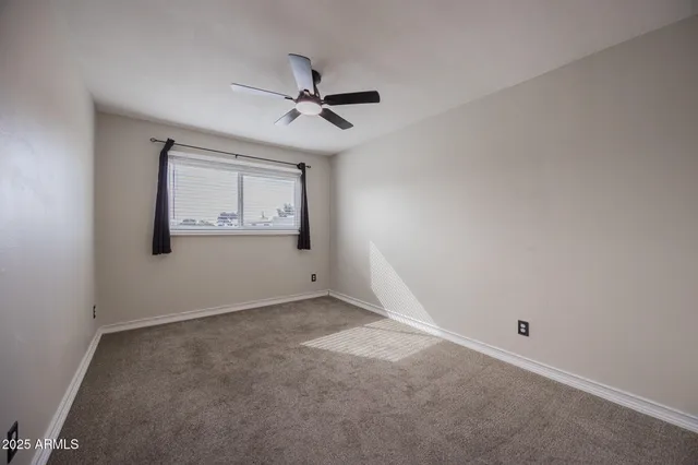 a view of a big room with wooden floor closet and windows