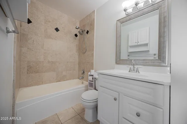 an empty room with a window and a ceiling fan