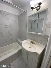5522 Wheeler Street Philadelphia, PA 19143 - Photo 5 of 7 a bathroom with a sink and mirror