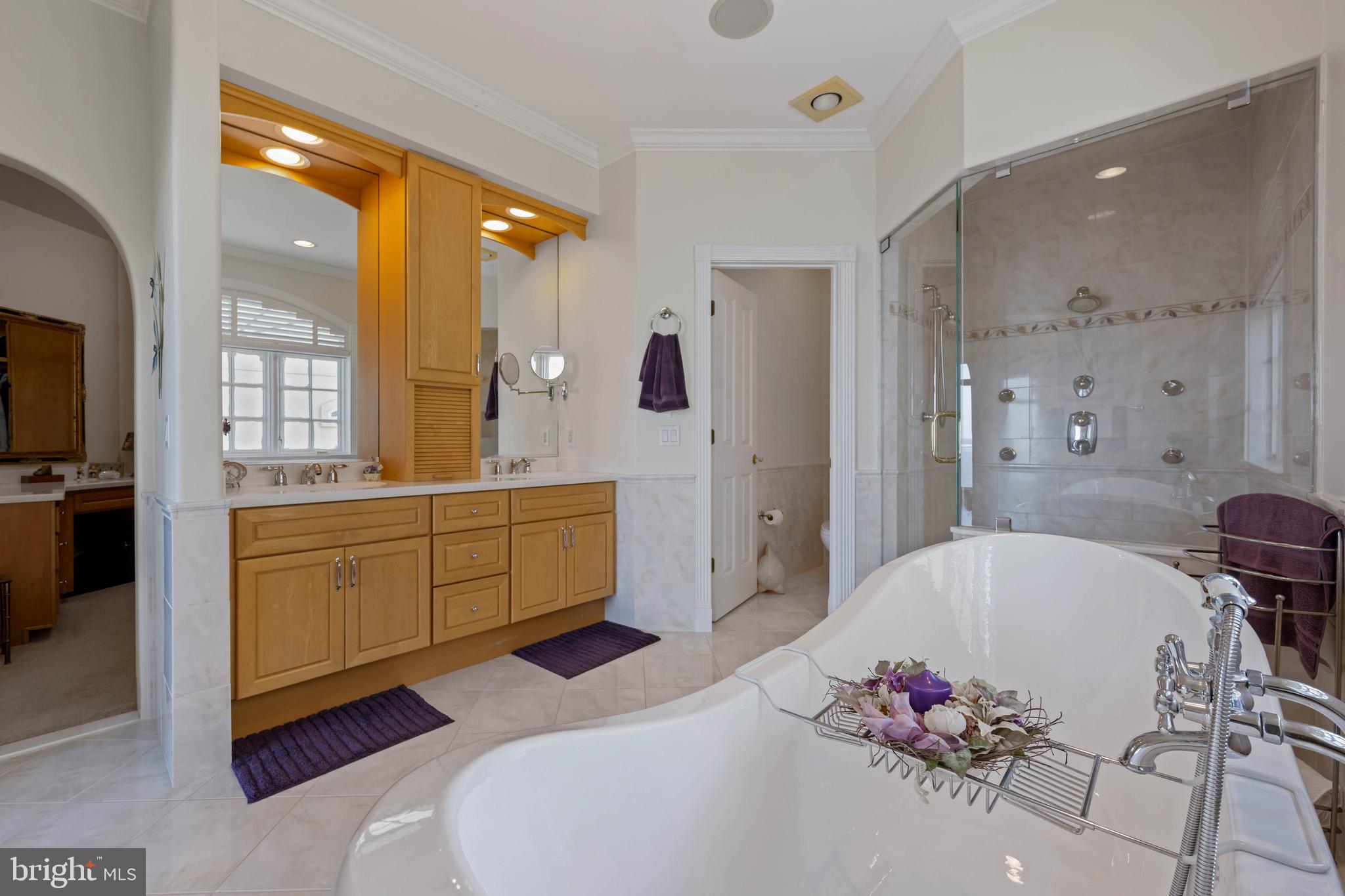 12959 Harbor Road Ocean City, MD 21842 - Photo 27 of 85 a spacious bathroom with a tub sink and mirror