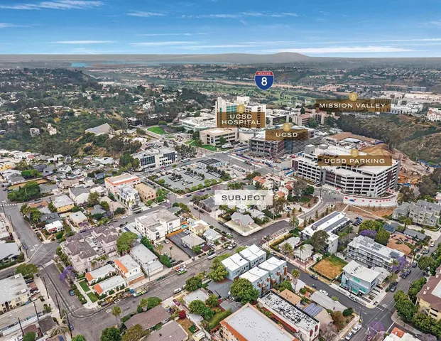 an aerial view of residential houses with city view