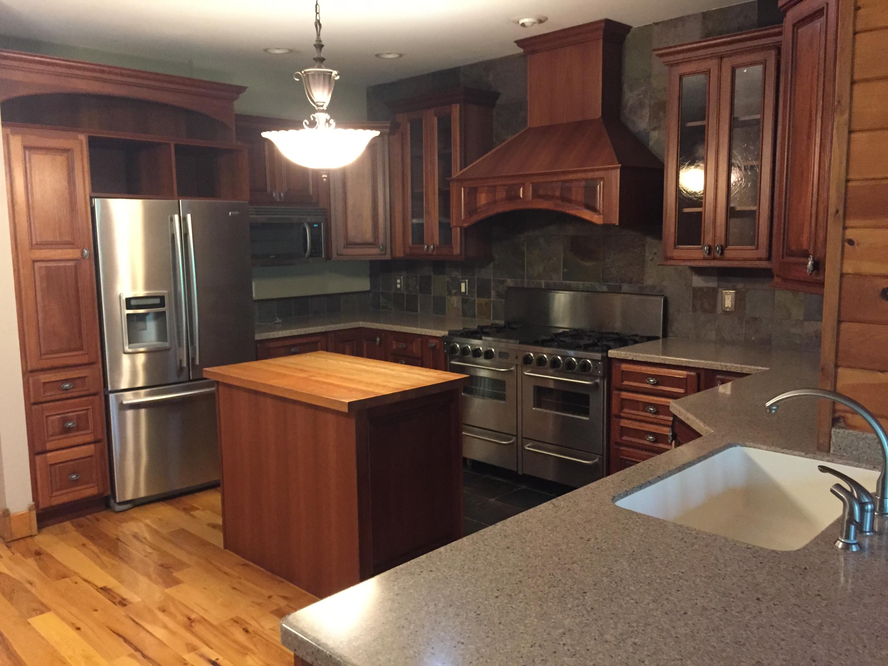 4560 White House Road Moneta, VA 24121 - Photo 10 of 17 a kitchen with stainless steel appliances granite countertop a sink a stove and a refrigerator