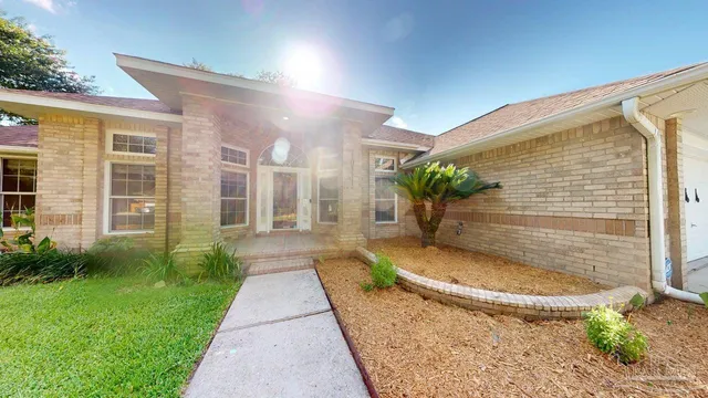 a view of a house with a yard and tree s