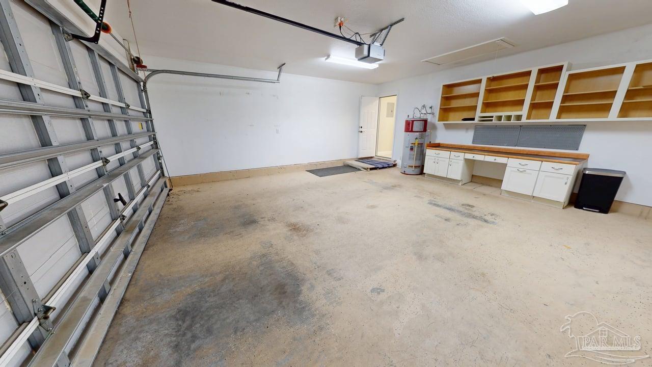 10111 Bristol Park Road Cantonment, FL 32533 - Photo 13 of 72 a view of an empty room with wooden floor and windows