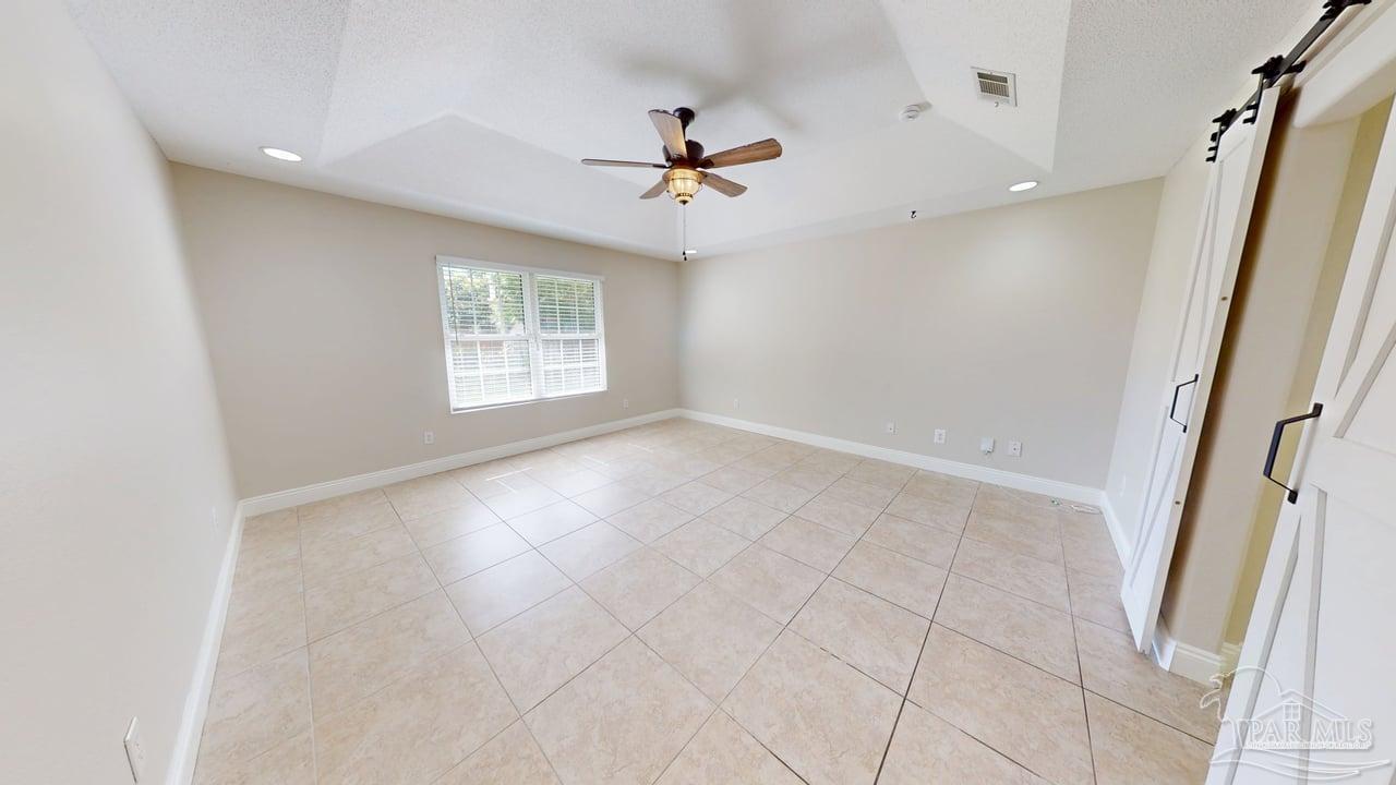 10111 Bristol Park Road Cantonment, FL 32533 - Photo 16 of 72 an empty room with windows and fan