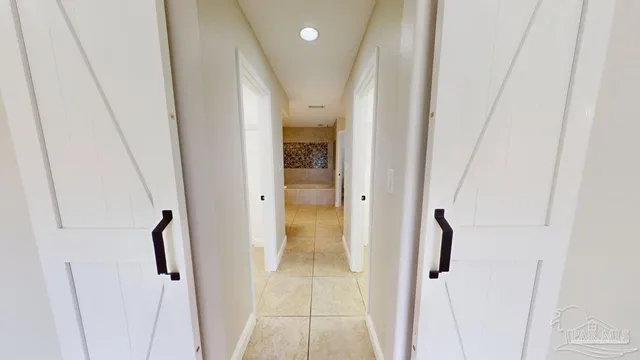 a spacious bathroom with a double vanity sink a mirror and a bathtub