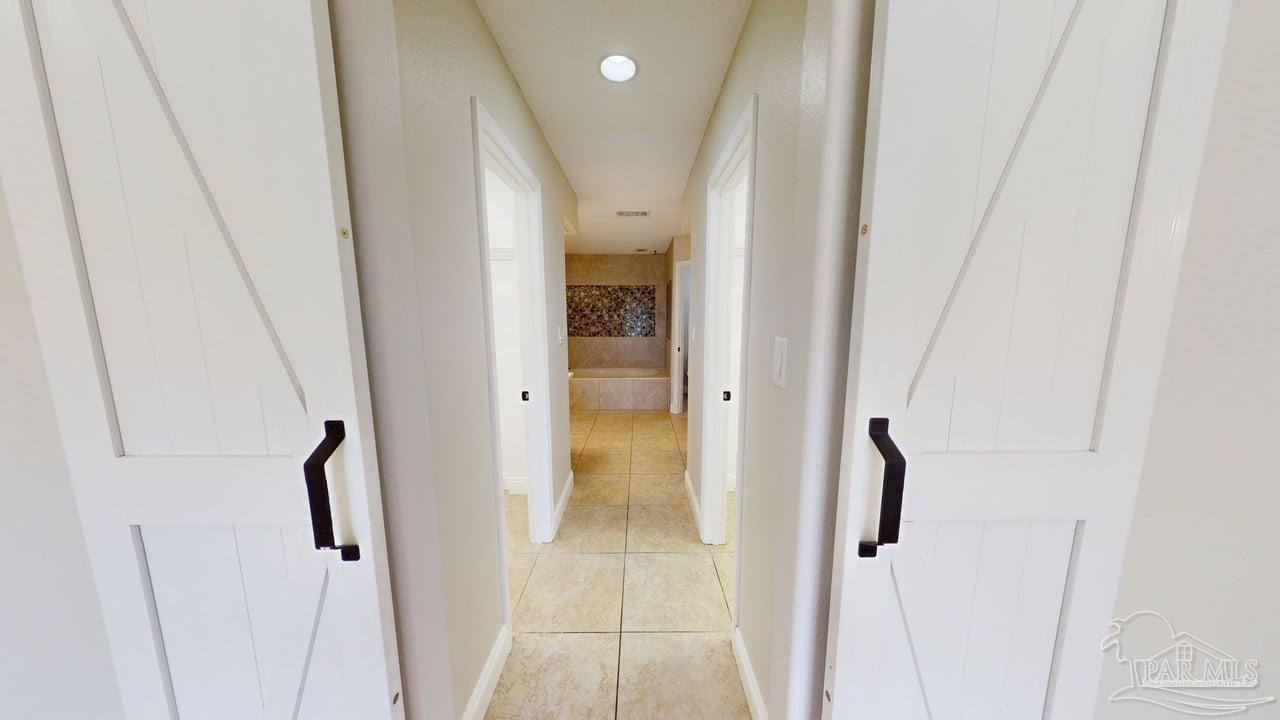 10111 Bristol Park Road Cantonment, FL 32533 - Photo 17 of 72 a view of a bathroom from a hallway