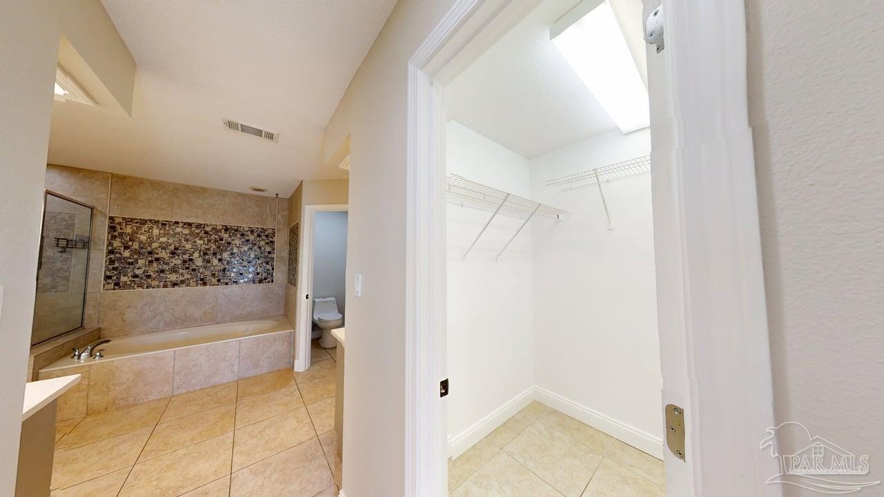 10111 Bristol Park Road Cantonment, FL 32533 - Photo 18 of 72 a bathroom with a bathtub and shower