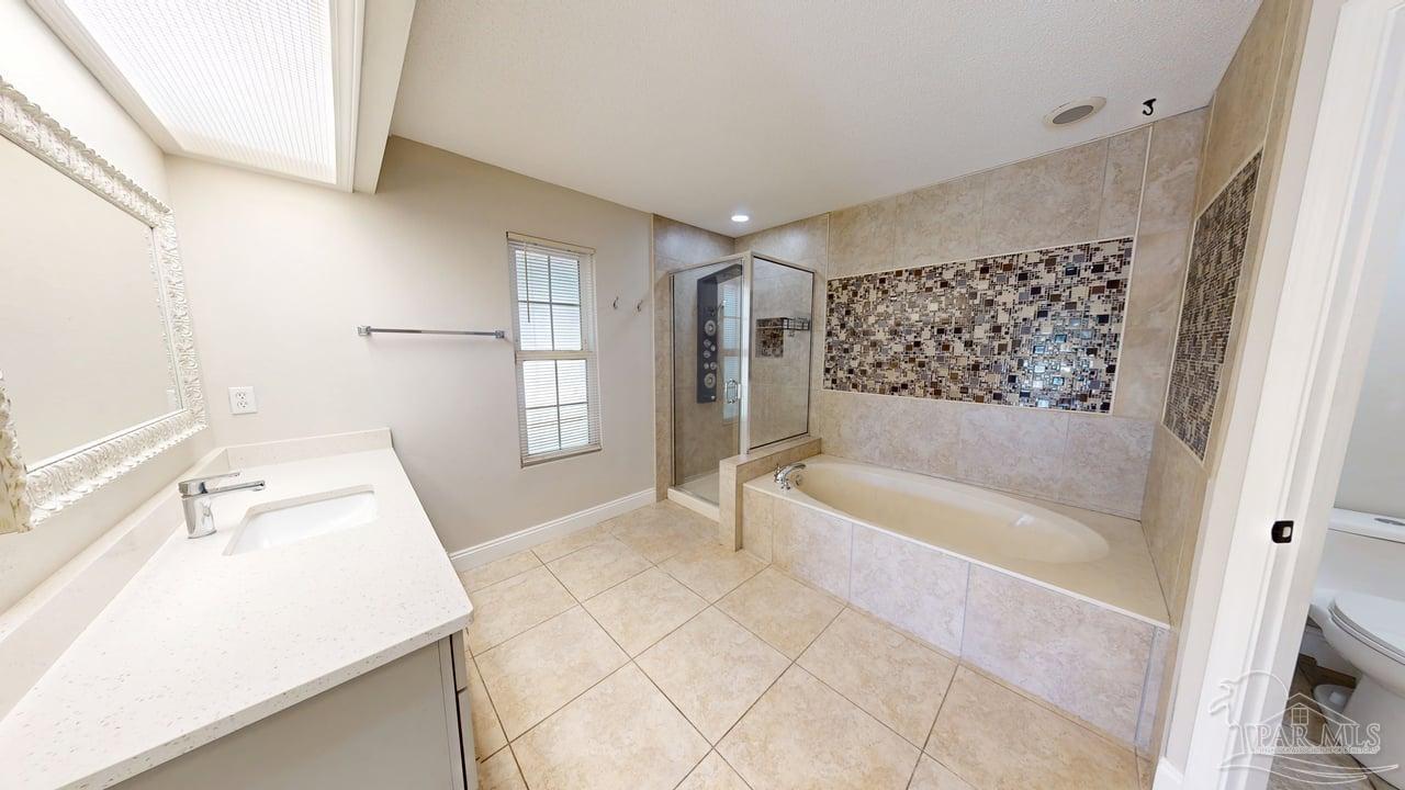 10111 Bristol Park Road Cantonment, FL 32533 - Photo 19 of 72 a bathroom with a tub sink and mirror