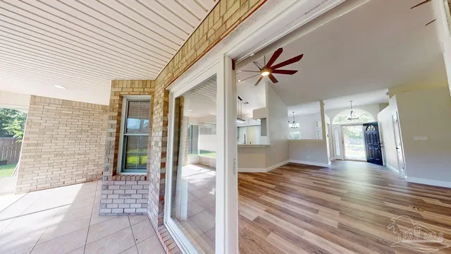 a view of a hallway with wooden floor and entryway