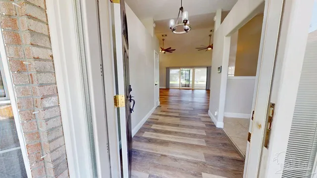 a view of a livingroom with wooden floor and a fireplace