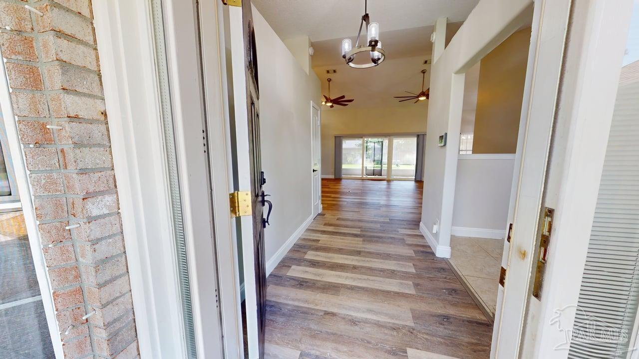 10111 Bristol Park Road Cantonment, FL 32533 - Photo 3 of 72 a view of a hallway with wooden floor and staircase