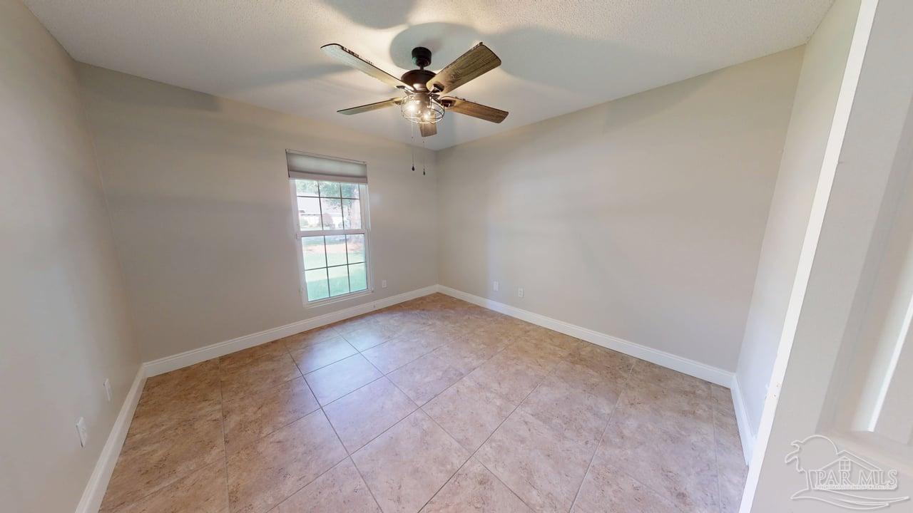 10111 Bristol Park Road Cantonment, FL 32533 - Photo 37 of 72 en empty room with windows and fan