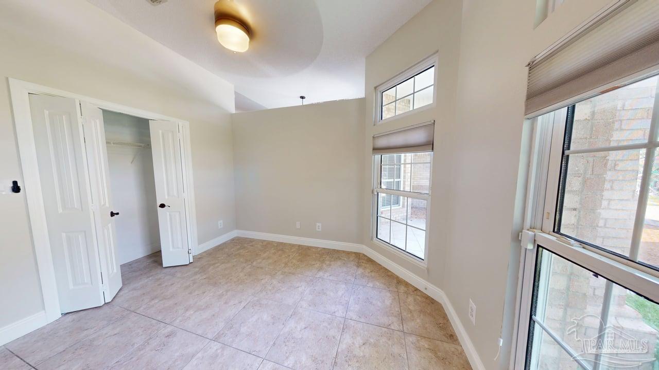 10111 Bristol Park Road Cantonment, FL 32533 - Photo 40 of 72 a view of an empty room with wooden floor and windows