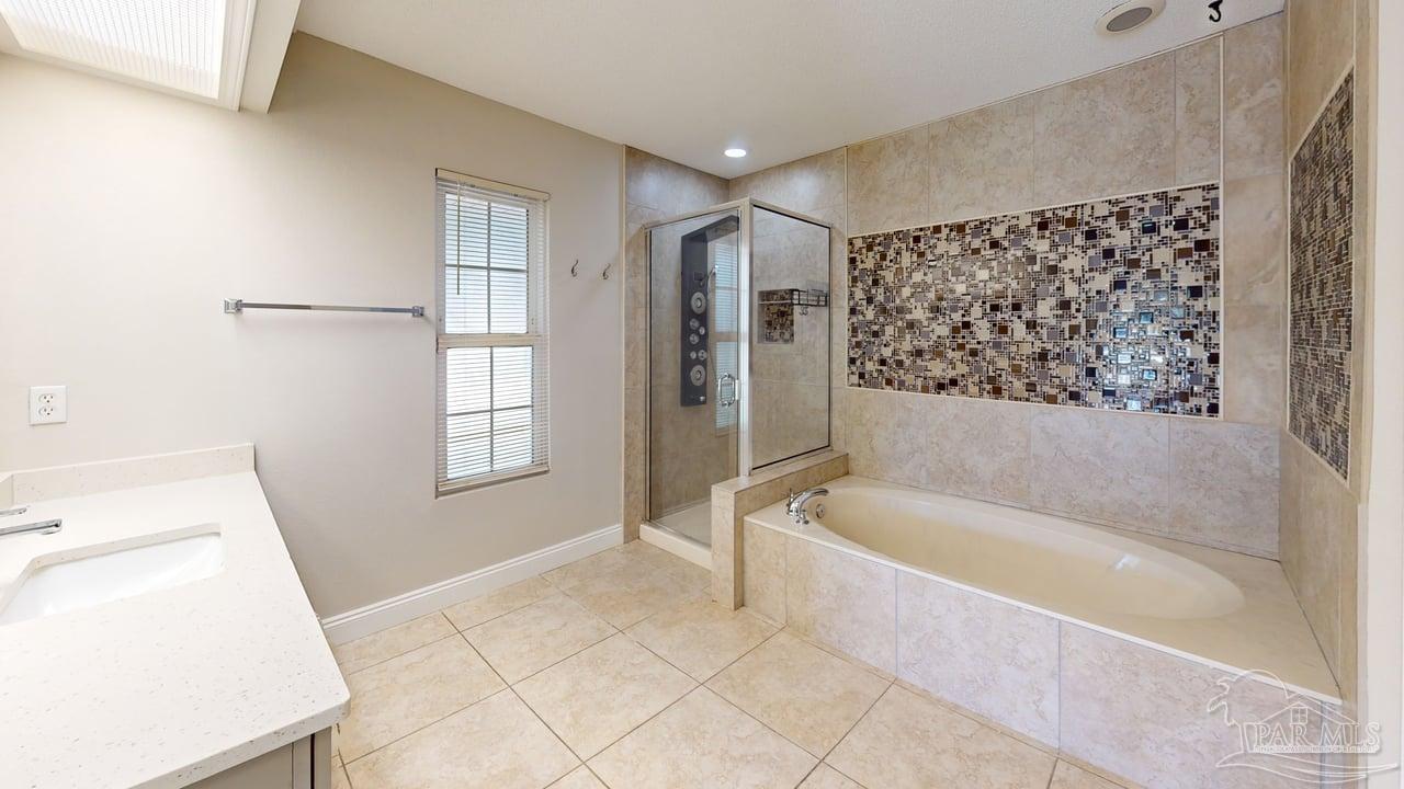 10111 Bristol Park Road Cantonment, FL 32533 - Photo 45 of 72 a bathroom with a bathtub and a shower