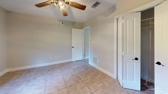 a view of green field with tree in the background