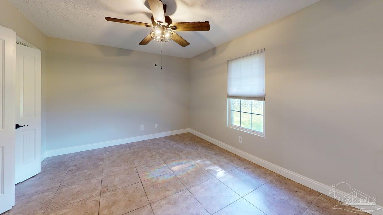 10111 Bristol Park Road Cantonment, FL 32533 - Photo 49 of 72 wooden floor in an empty room with a window