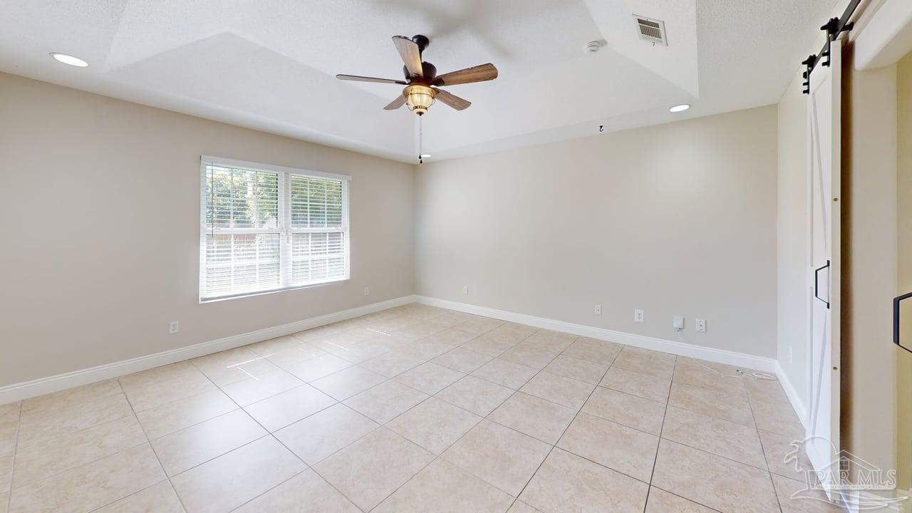 10111 Bristol Park Road Cantonment, FL 32533 - Photo 54 of 72 an empty room with windows and ceiling fan