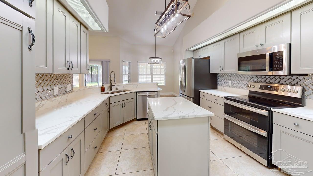 10111 Bristol Park Road Cantonment, FL 32533 - Photo 61 of 72 a kitchen with granite countertop a sink stainless steel appliances and cabinets