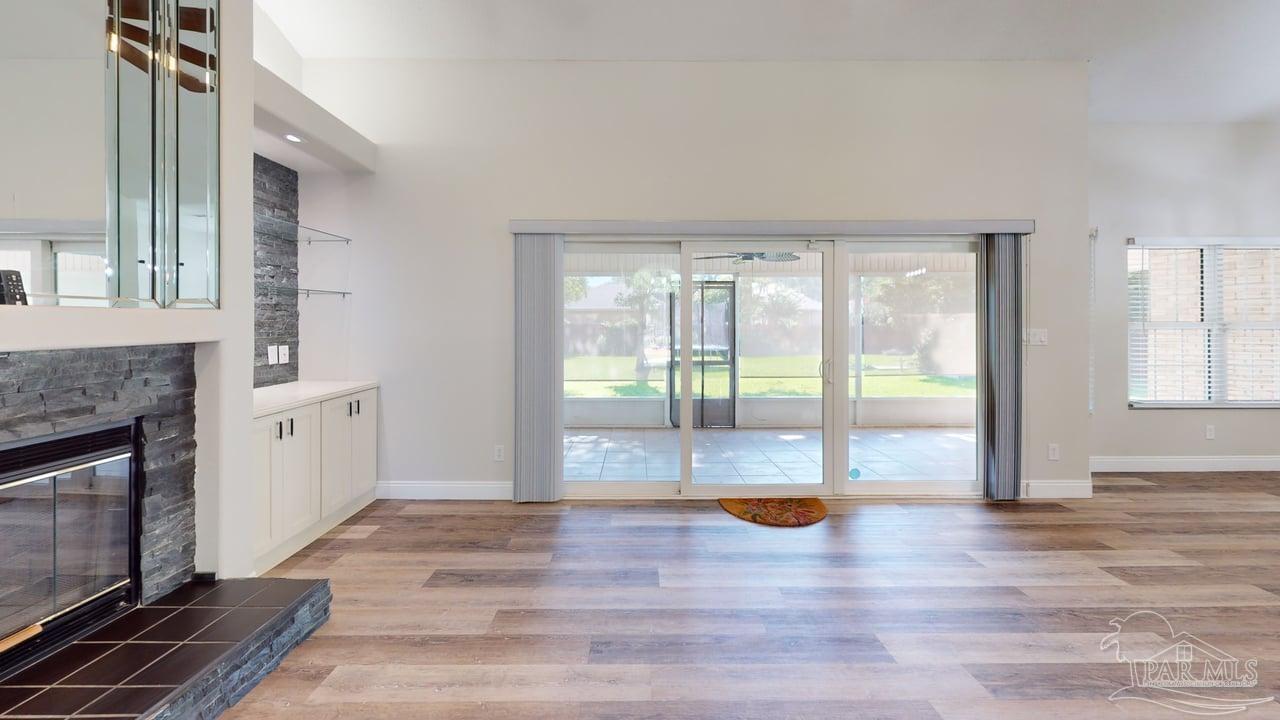 10111 Bristol Park Road Cantonment, FL 32533 - Photo 65 of 72 a view of empty room with wooden floor and fireplace