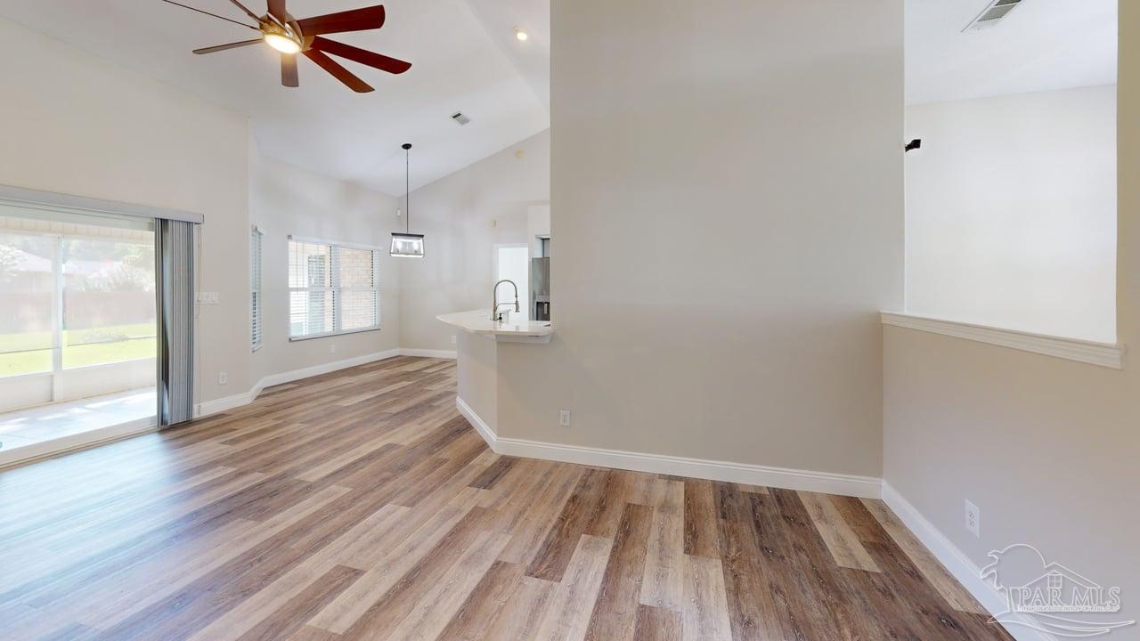 10111 Bristol Park Road Cantonment, FL 32533 - Photo 66 of 72 a view of empty room with wooden floor and fan