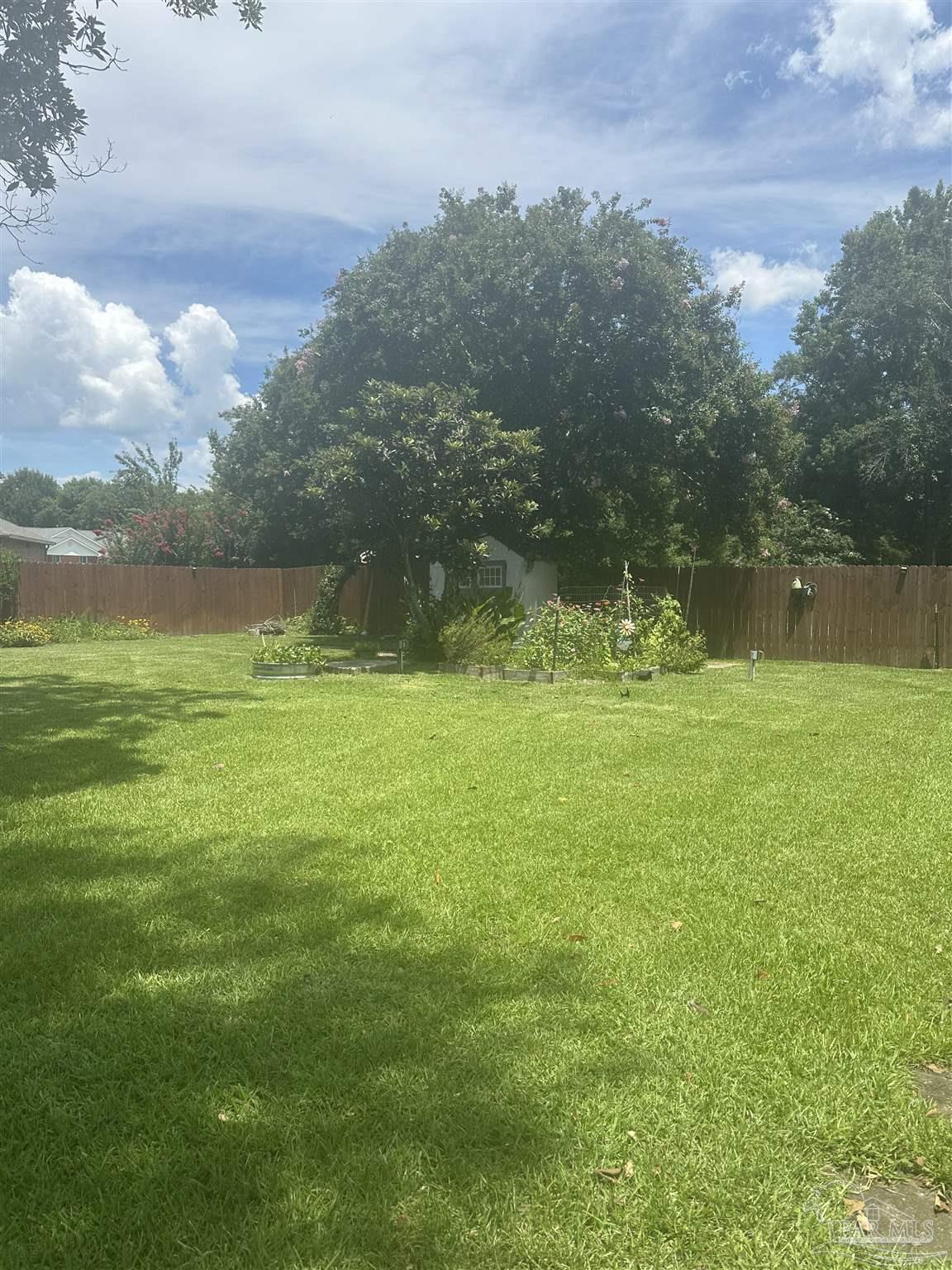10111 Bristol Park Road Cantonment, FL 32533 - Photo 70 of 72 a view of a field with an trees in the background