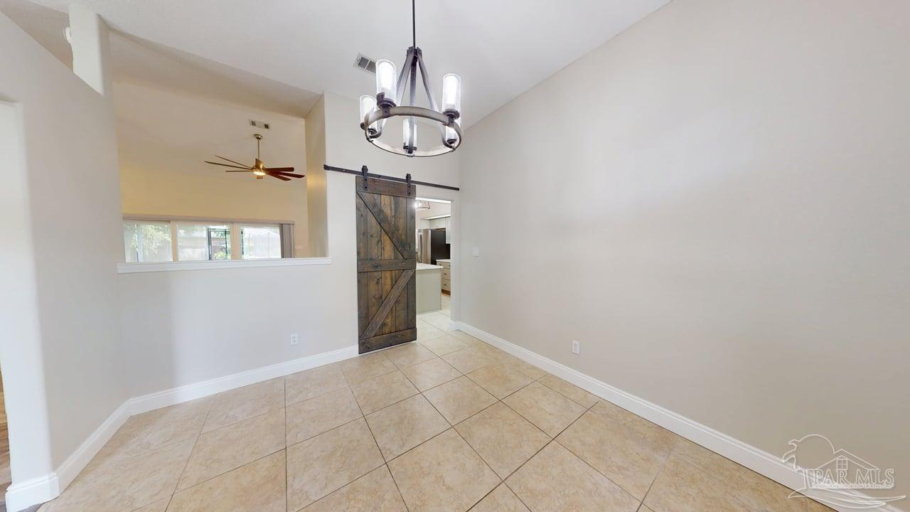 10111 Bristol Park Road Cantonment, FL 32533 - Photo 8 of 72 a view of a hallway with a chandelier fan and windows