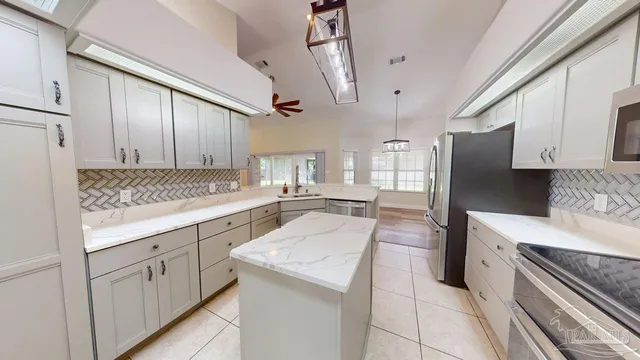 a kitchen with white cabinets and white appliances