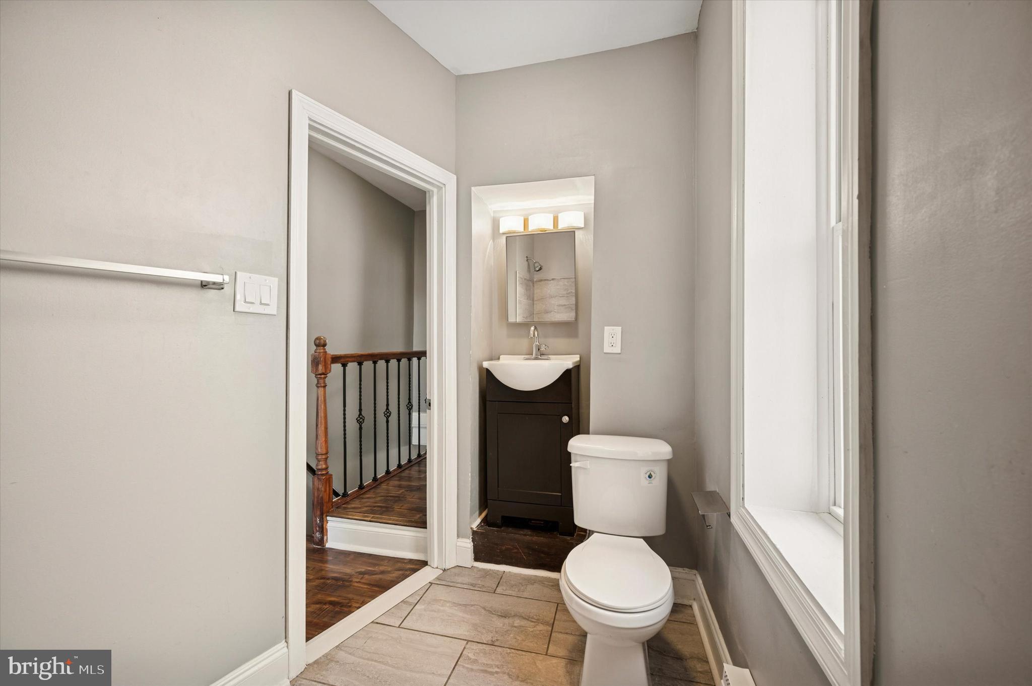 2147 North Marston Street Philadelphia, PA 19121 - Photo 12 of 15 a white toilet sitting next to a bathroom sink