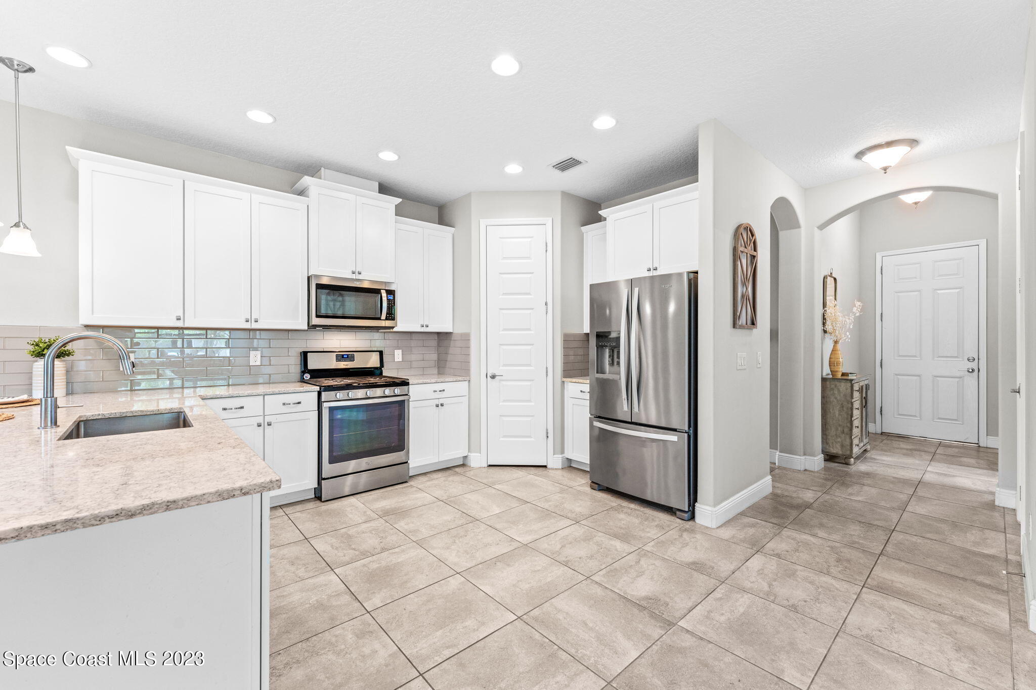 3640 Stabane Place Melbourne, FL 32940 - Photo 17 of 85 a kitchen with stainless steel appliances granite countertop a refrigerator and a stove top oven