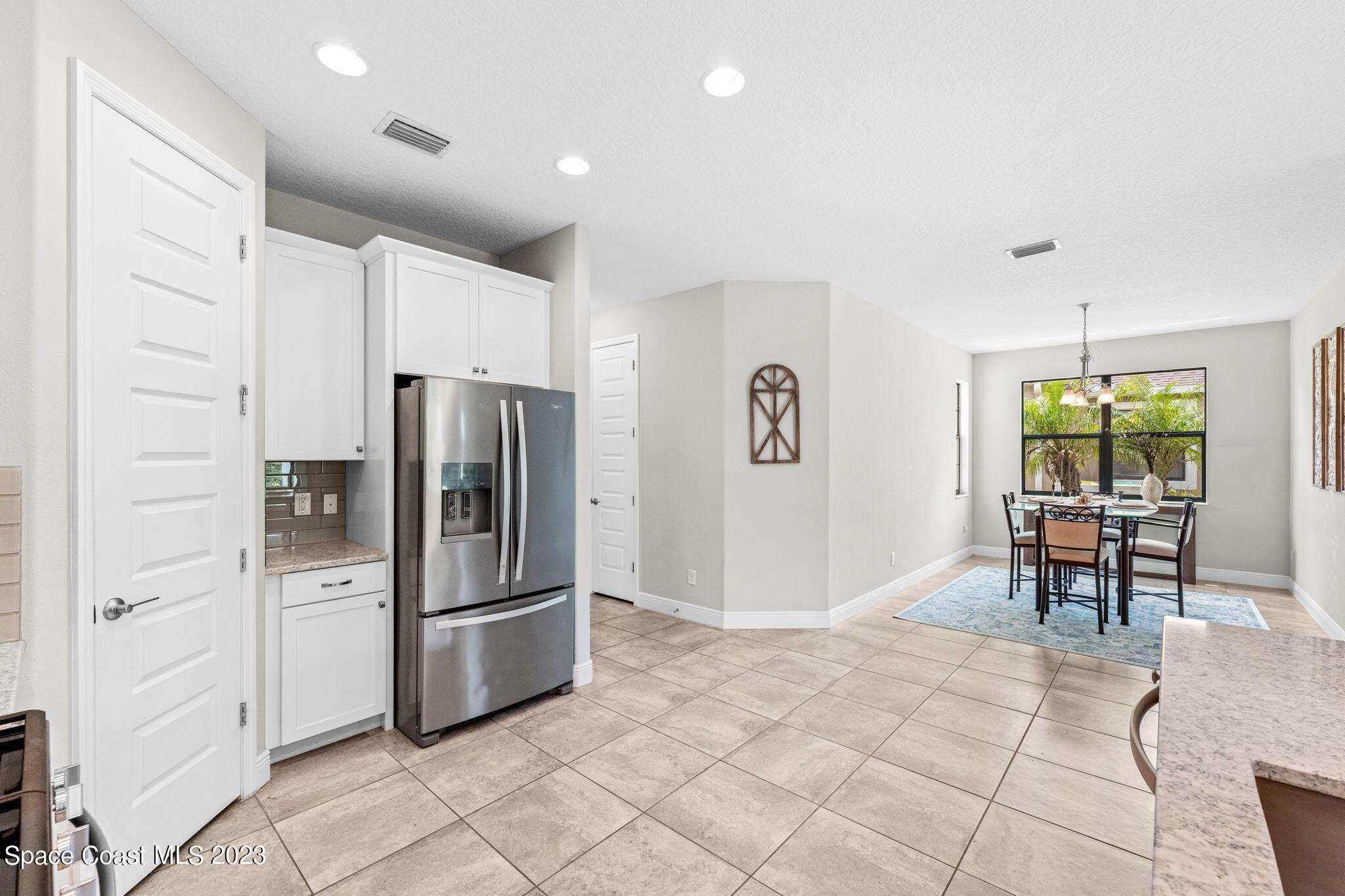 3640 Stabane Place Melbourne, FL 32940 - Photo 22 of 85 a kitchen with stainless steel appliances a refrigerator and a table
