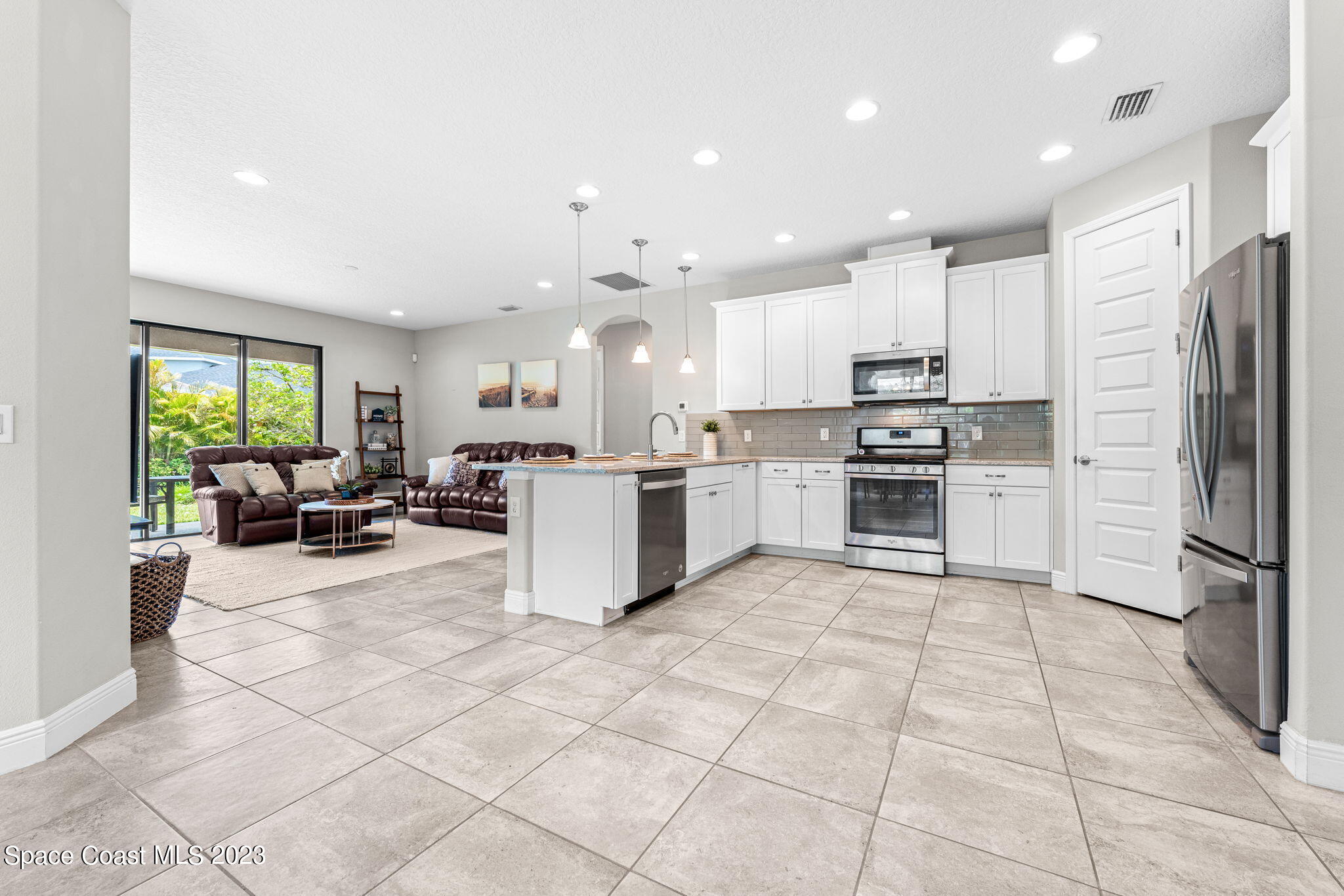 3640 Stabane Place Melbourne, FL 32940 - Photo 23 of 85 a kitchen with stainless steel appliances a refrigerator sink and cabinets