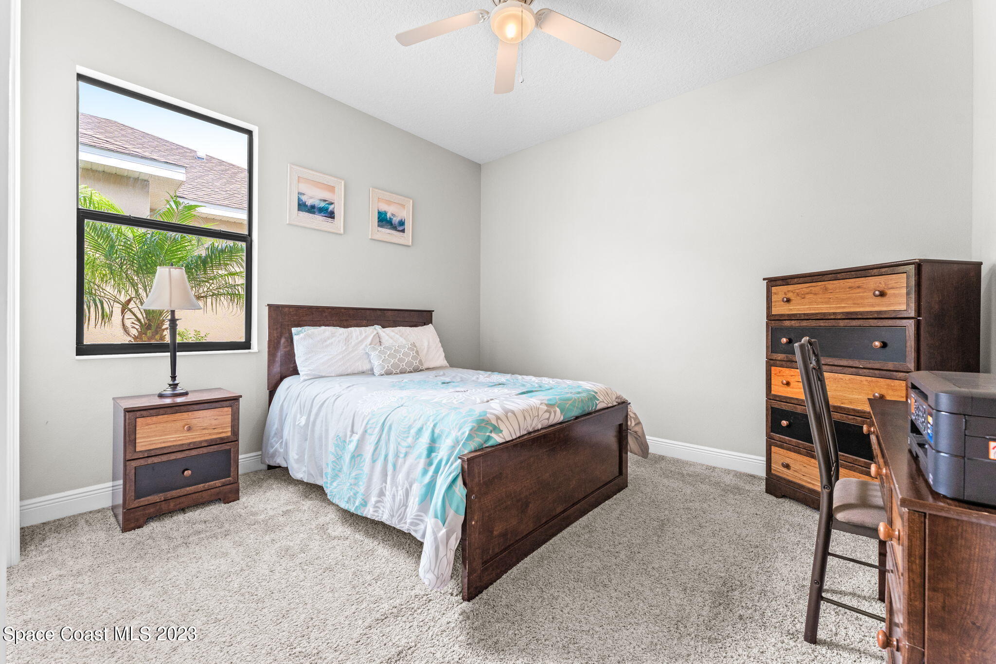 3640 Stabane Place Melbourne, FL 32940 - Photo 35 of 85 a bedroom with a bed and a chandelier