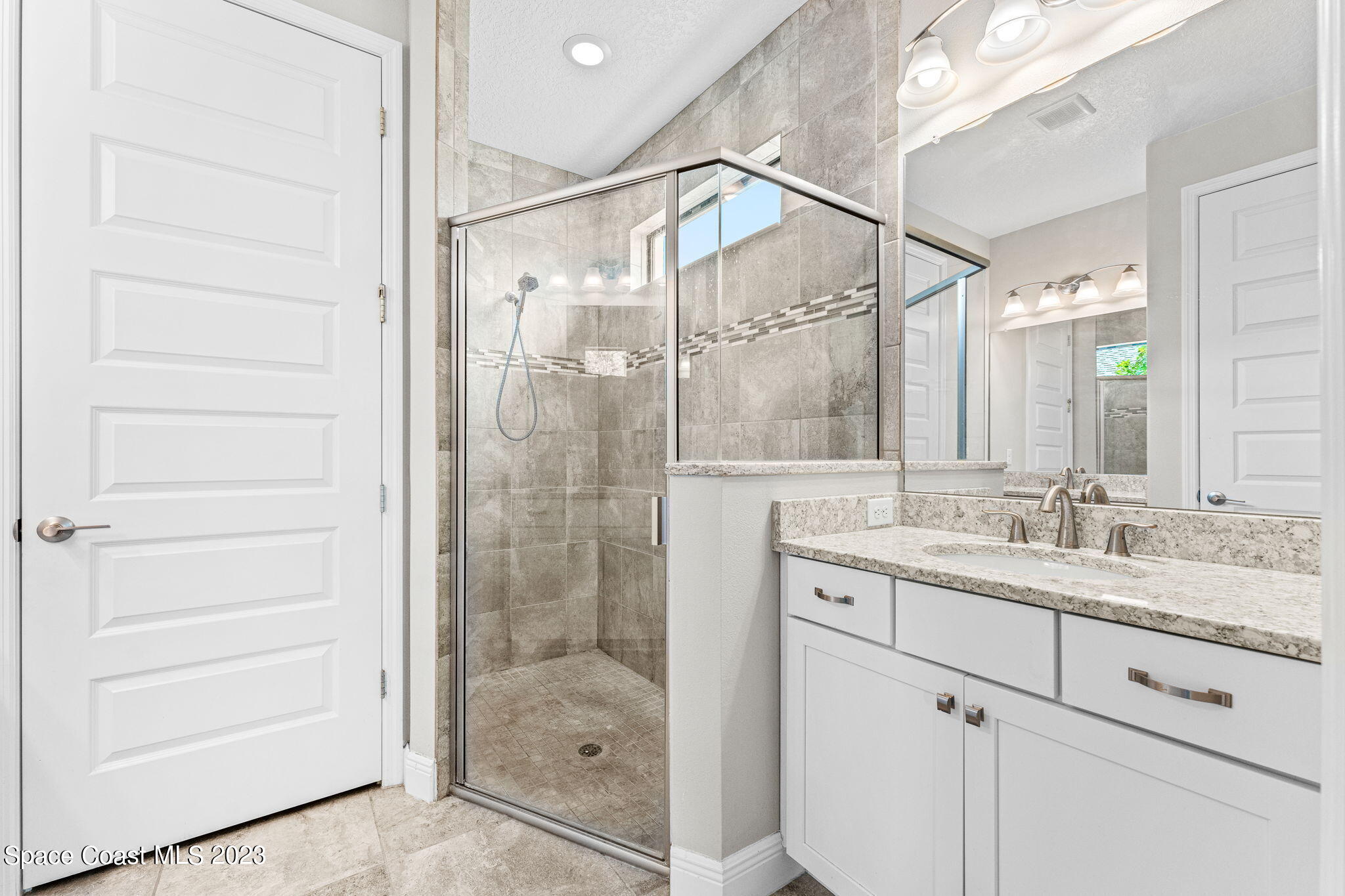 3640 Stabane Place Melbourne, FL 32940 - Photo 40 of 85 a bathroom with a shower sink and mirror