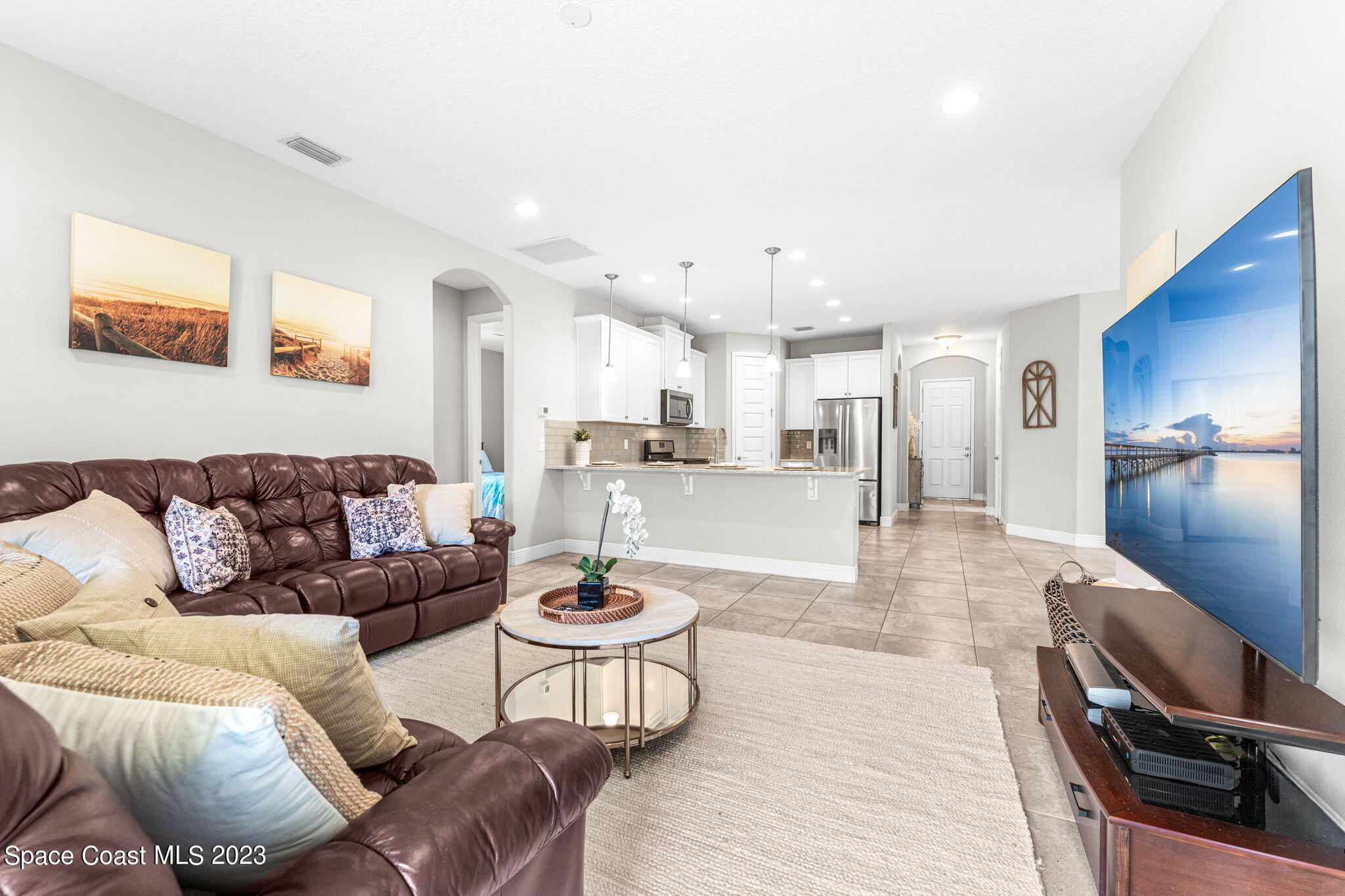 3640 Stabane Place Melbourne, FL 32940 - Photo 43 of 85 a living room with furniture and a dining table with wooden floor