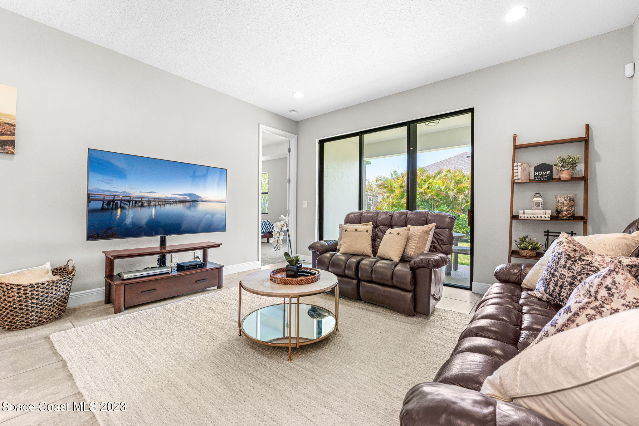 3640 Stabane Place Melbourne, FL 32940 - Photo 44 of 85 a living room with furniture and a flat screen tv